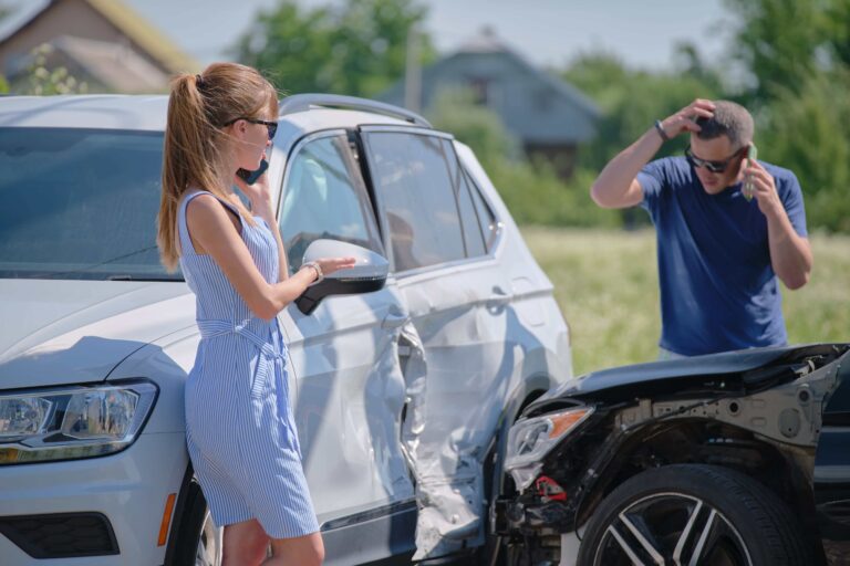 Man and woman on the phone with their insurance agency after a car accident